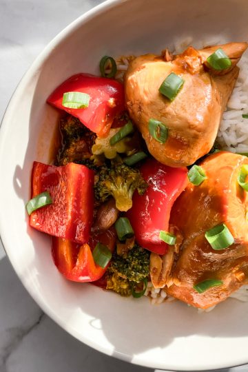 Honey garlic chicken and rice in a white bowl.