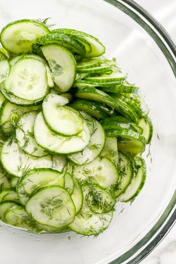 A bowl of sliced cucumber dill salad.